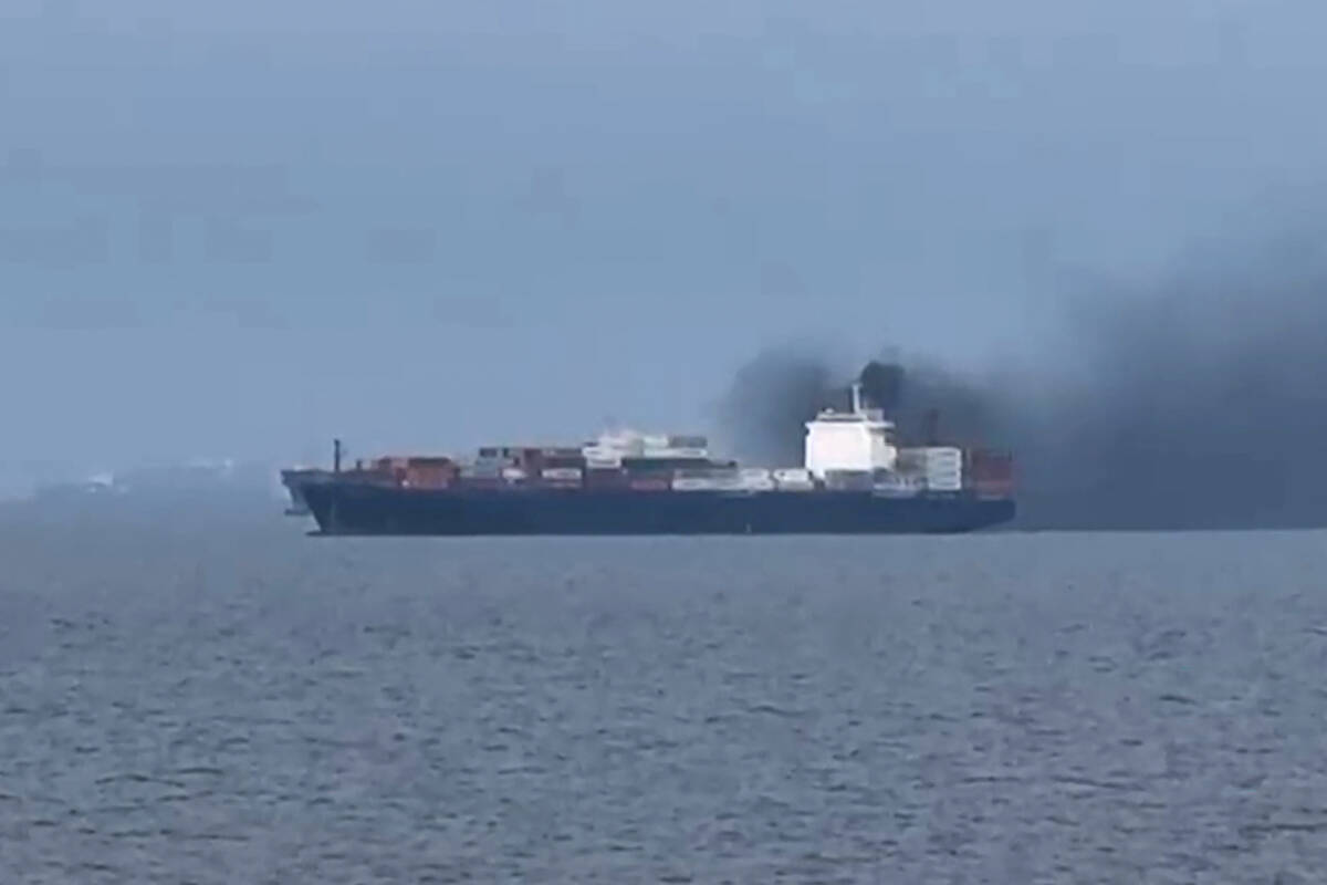 This frame grab from handout UGC video footage by seafarer Wang Shang taken on March 12, 2026 and released to AFPTV on March 13 shows smoke emerging from the Source Blessing cargo vessel, as filmed from the vessel Wang was onboard in the Gulf, north of Dubai. AFP PHOTO/WANG SHANG/UGC via AFPTV/HANDOUT
