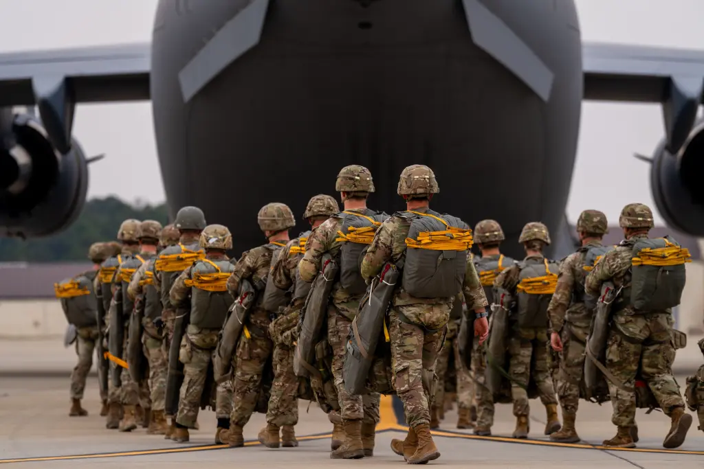 Paratroopers with the 82nd Airborne Division walk to a C-17 Globemaster III at Fort Bragg, North Carolina, on March 13, 2026. - US Army